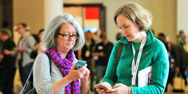 SXSW EDU 2017 attendees checking the mobile app. Photo by Nicole Burton.