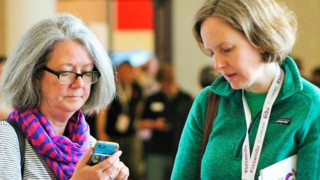 SXSW EDU 2017 attendees checking the mobile app. Photo by Nicole Burton.