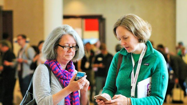 SXSW EDU 2017 attendees checking the mobile app. Photo by Nicole Burton.