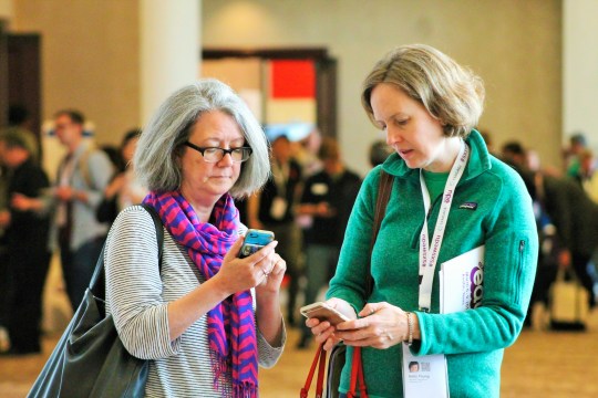 SXSW EDU 2017 attendees checking the mobile app. Photo by Nicole Burton.